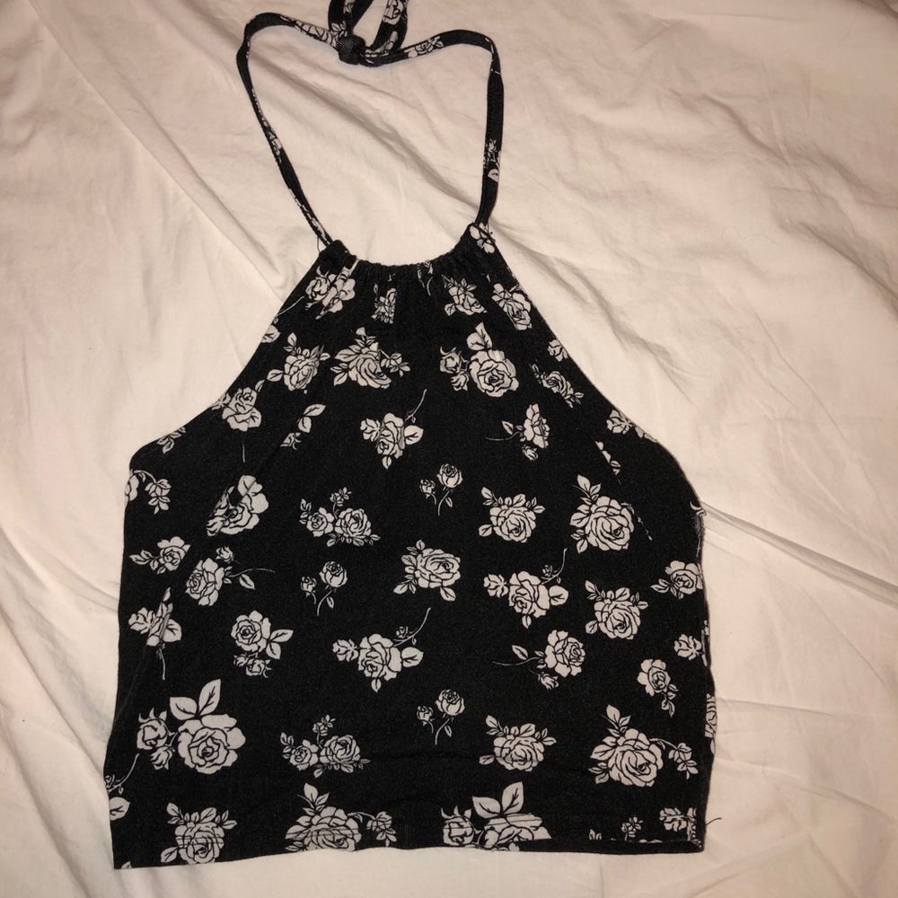 Around the neck black floral halter